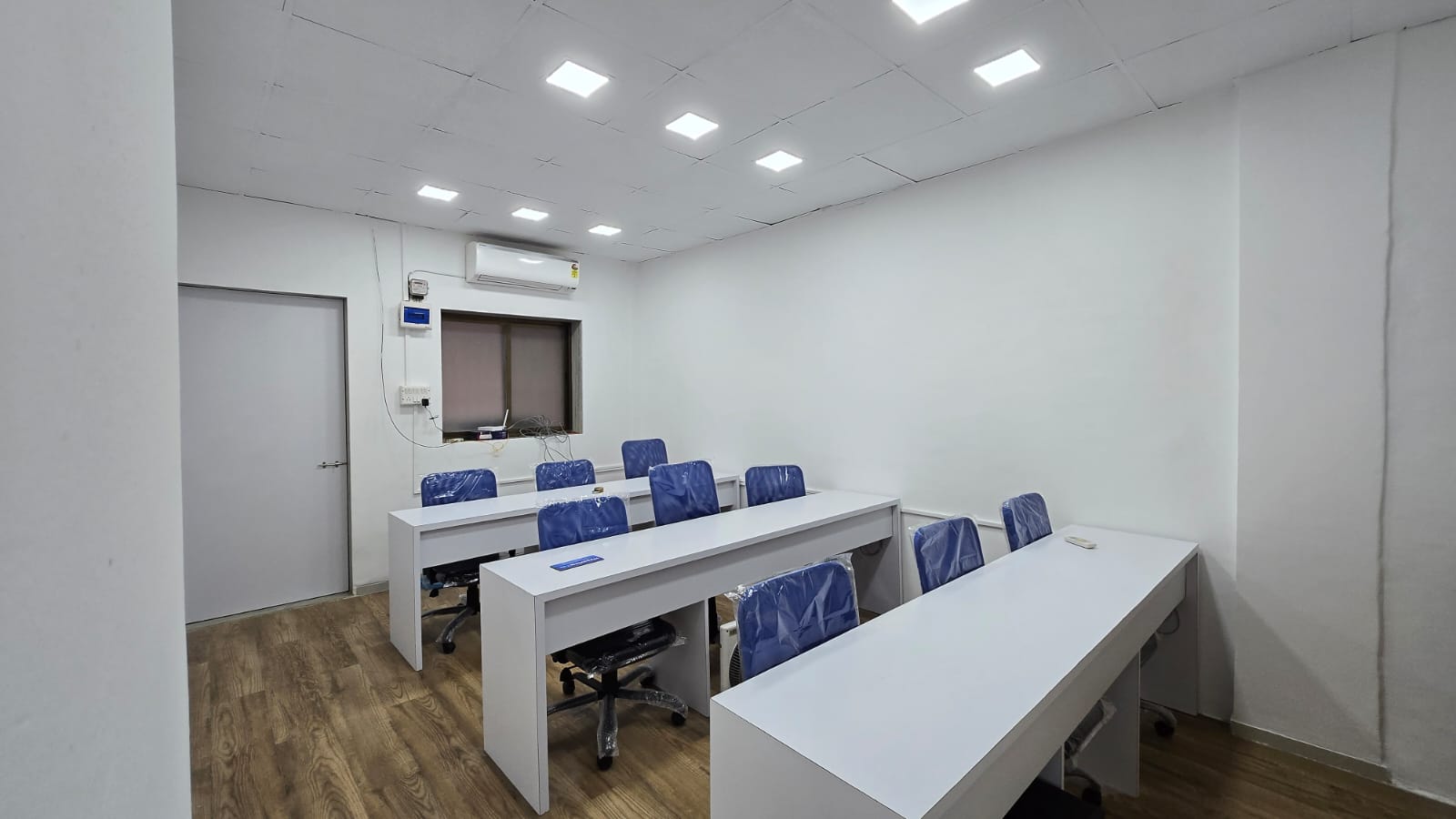 Our classroom with modern desks and blue chairs